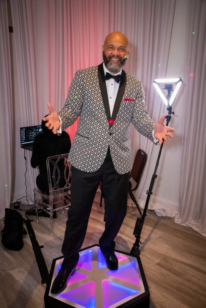 Professional DJ and MC with lighting equipment at a corporate event in the DMV area.