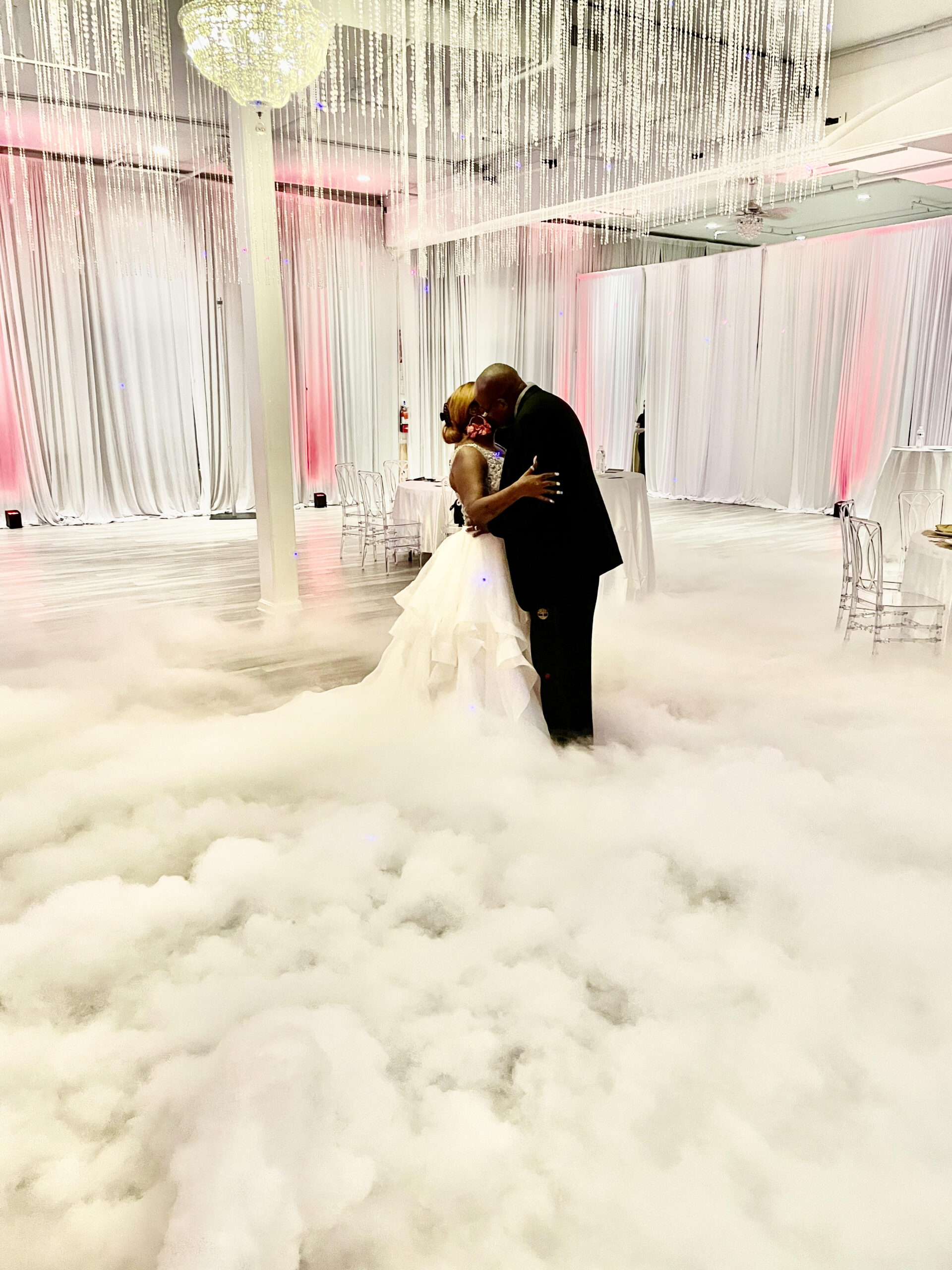 Couple's first dance enveloped in fog, creating a romantic and immersive wedding atmosphere.